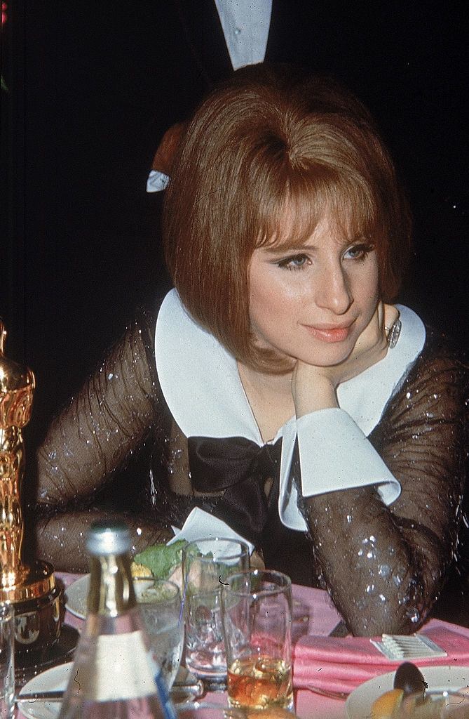 Barbra Streisand sitting at a table with her Best Actress Oscar award, 1969