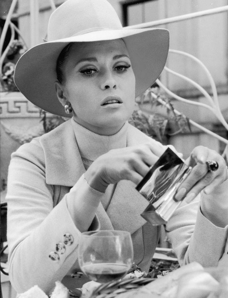 Faye Dunaway pulls a cigarette out of a silver case in the movie 'The Thomas Crowne Affair', 1968