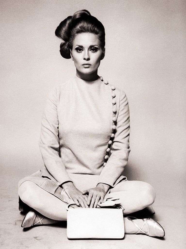 Faye Dunaway wearing a beige broadcloth straitline dress, 1969