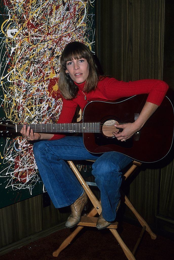 Jamie Lee Curtis playing guitar