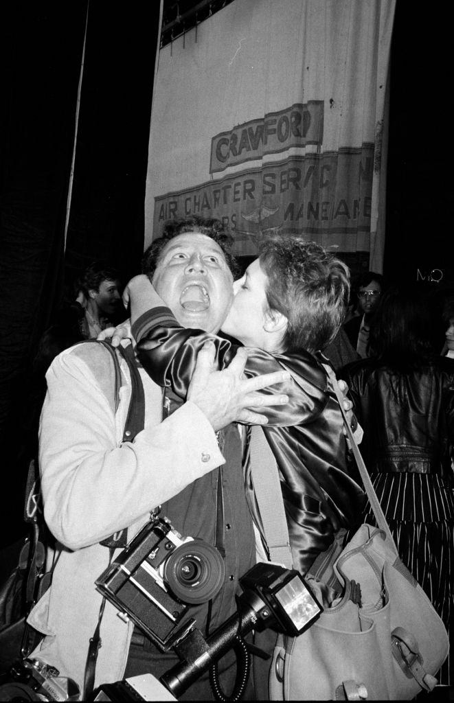 Jamie Lee Curtis kissing a photographer, 1982