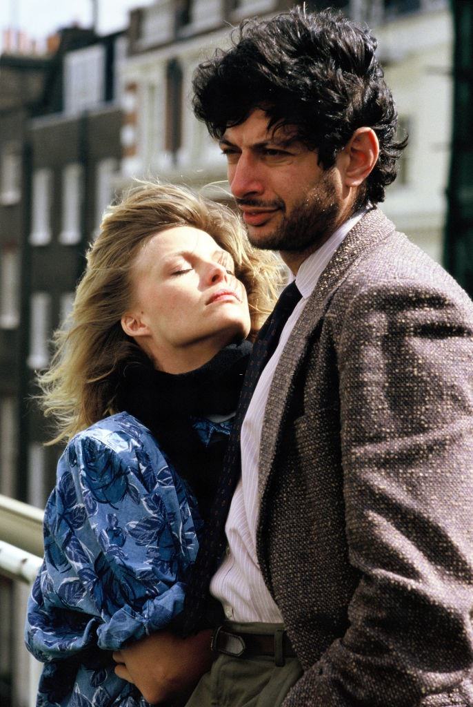 Michelle Pfeiffer with Jeff Goldblum pose on set during filming of 'Into The Night', 1985