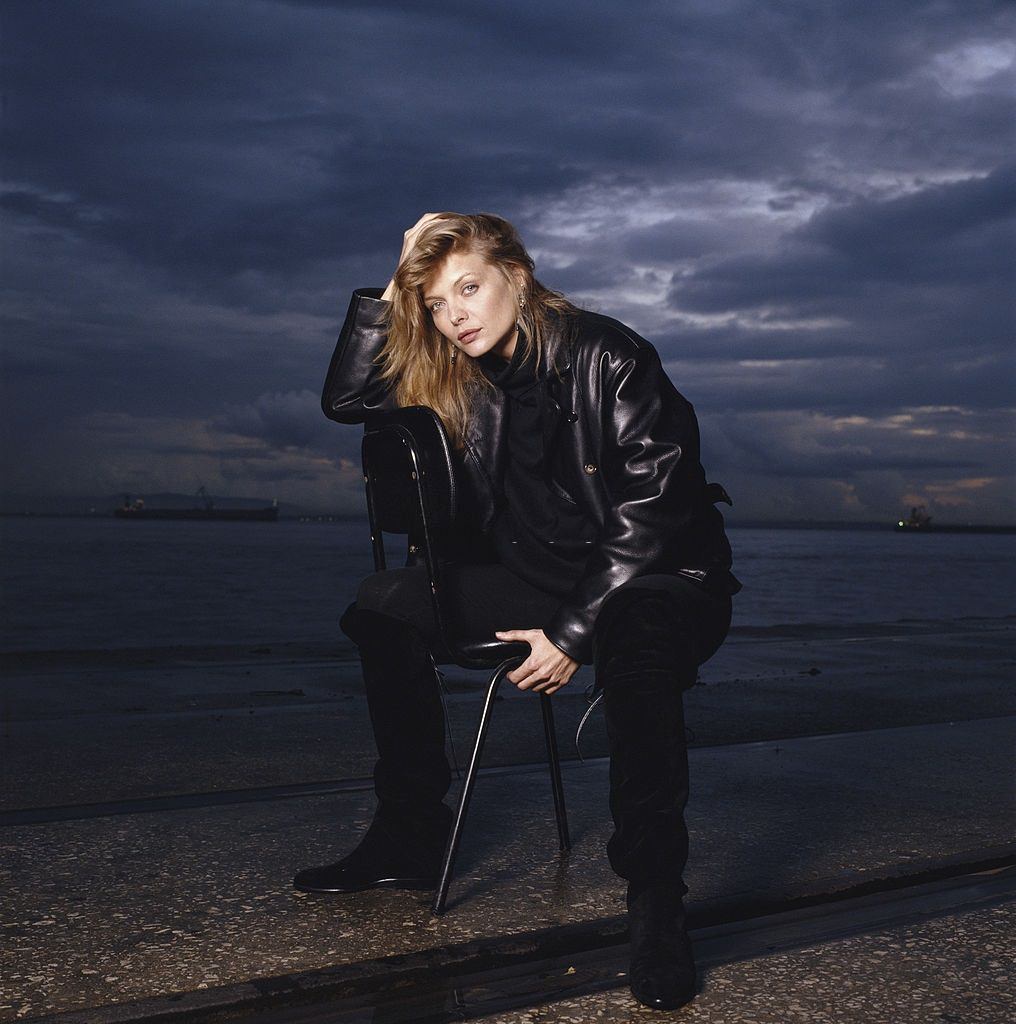 Michelle Pfeiffer posing by a beach in Portugal at dusk, 1990