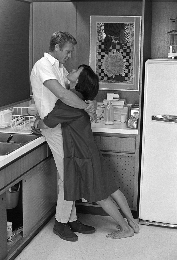 Neile Adams with her hsuband Steve McQueen in the kitch on their home, Hollywood, California, May 1963.