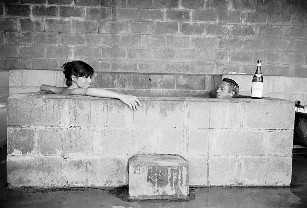 Neile Adams with her hsuband Steve McQueen sitting together in a sulphur bath, Big Sur, California, June 1963.