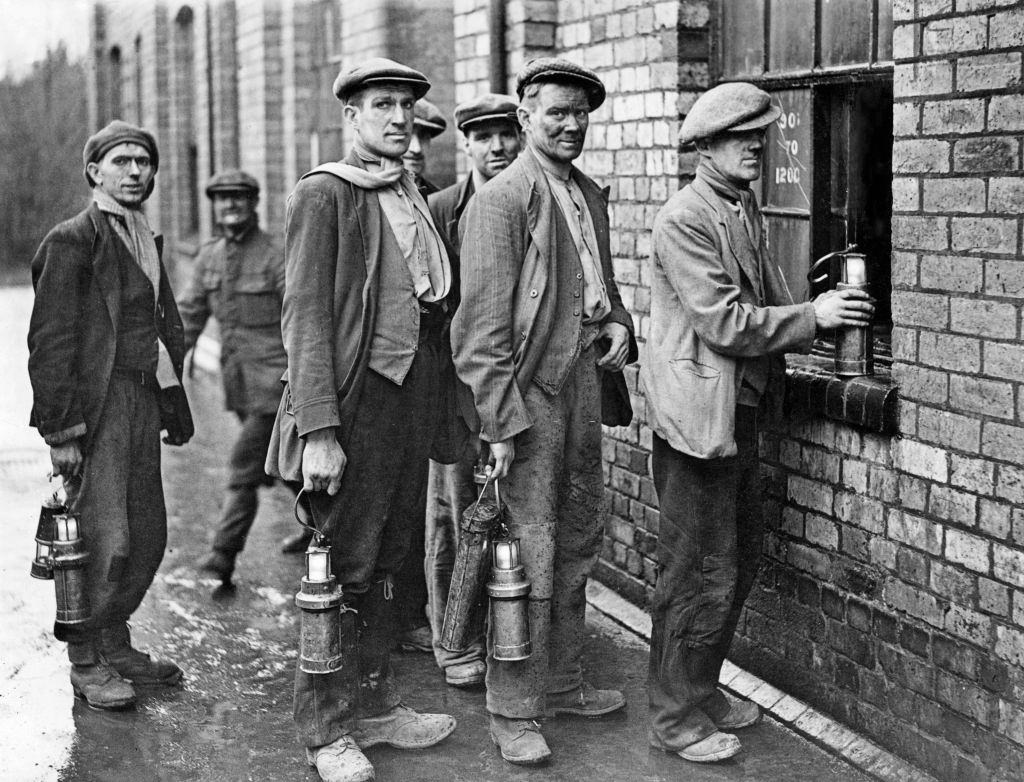 Miners at the Cannock Wood Pit handing in their Davy Lamps and lanterns at the end of their shift, 1939.