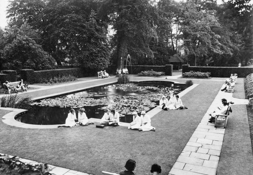 A break from work as Cadbury employees at Bournville rest up during the heatwave. West Midlands, Circa 1932.