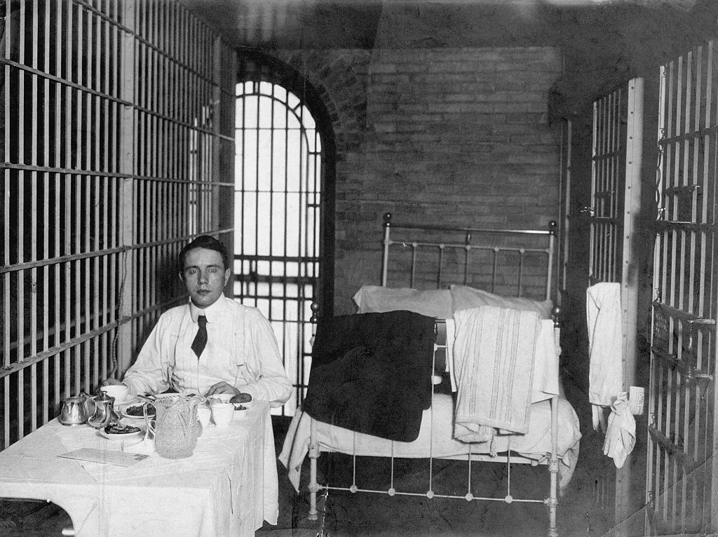 Wealthy accused murderer Harry K. Thaw eats a breakfast supplied by Delmonico's restaurant in his jail cell in New York City.