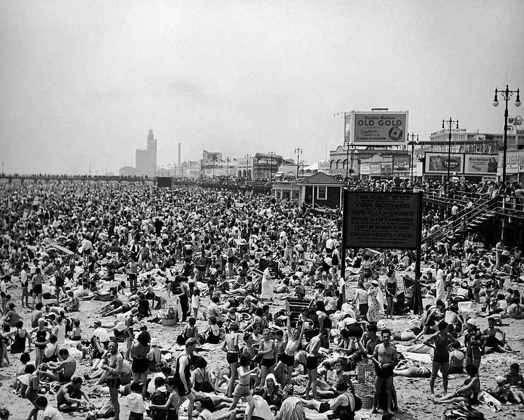 The beach and boardwalk at Coney Island, Brooklyn, New York City, 1930s.