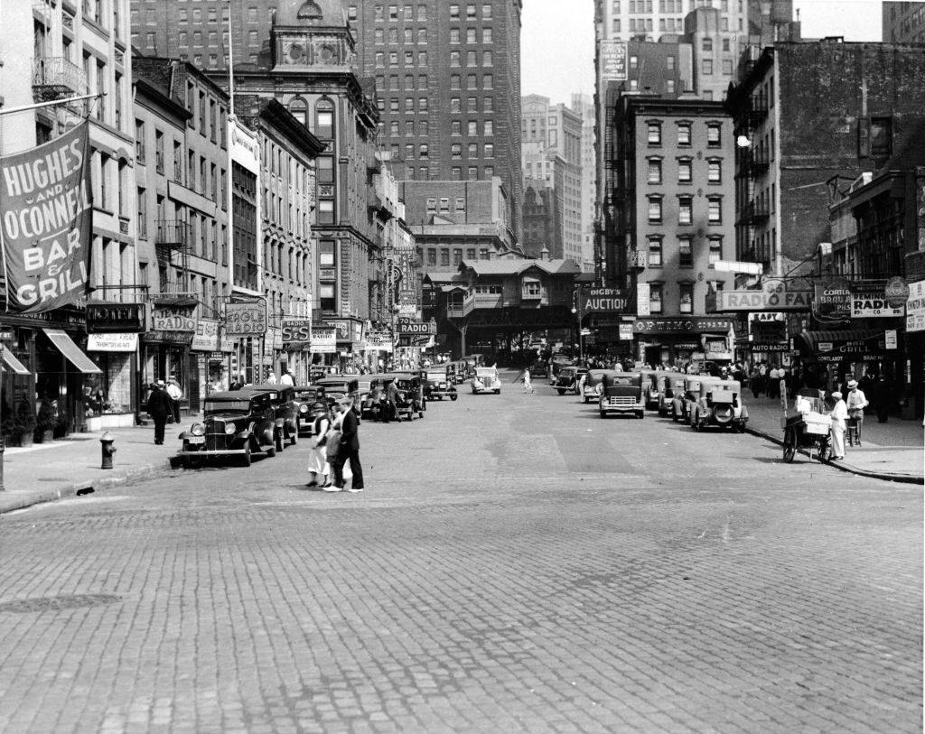 View east along Cortlandt Street across West Street, New York City, 1930s.