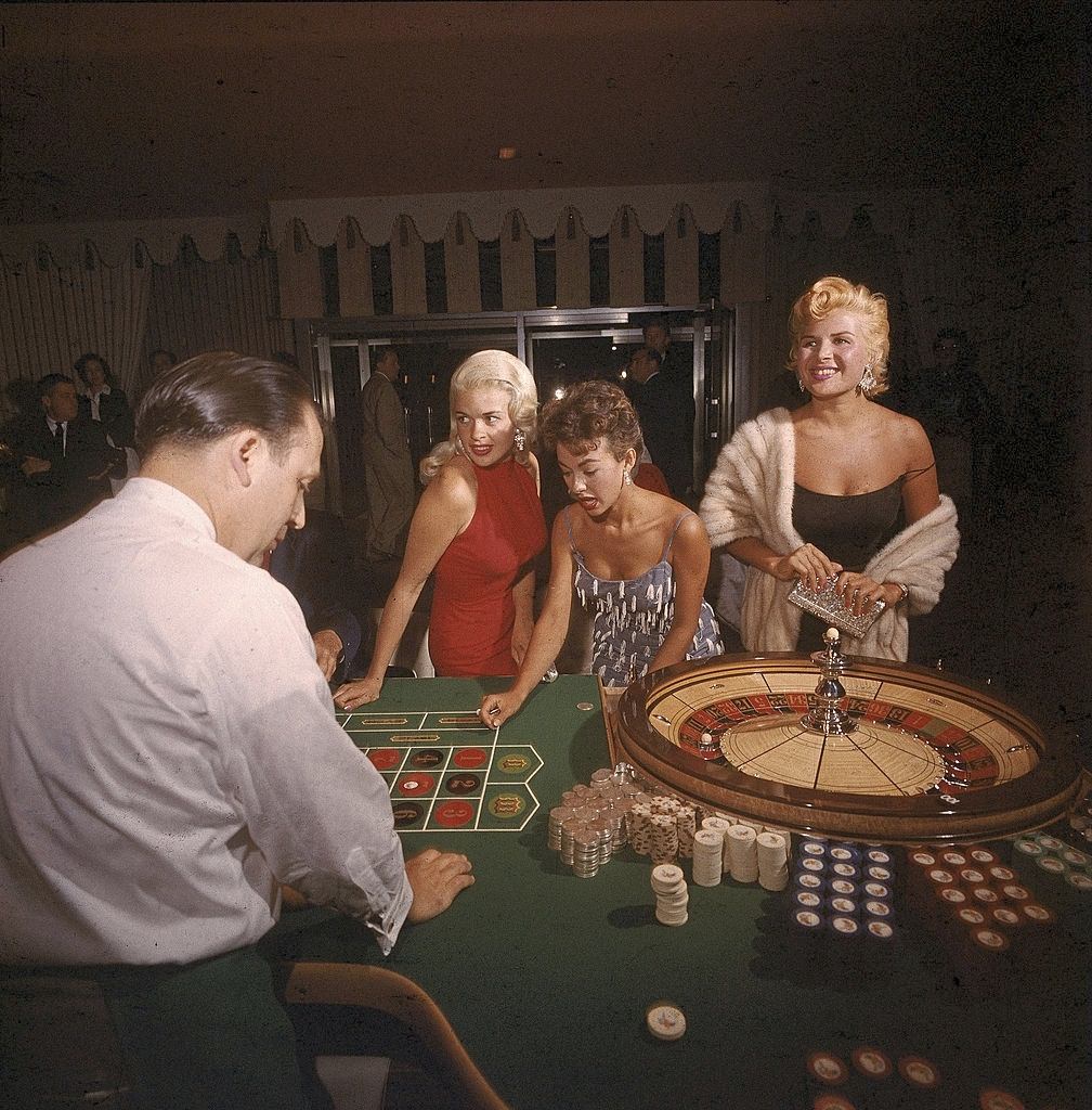 Jayne Mansfield with Rita Moreno and Gloria Paul at the roulette table in the Dunes casino, Las Vegas, 1955