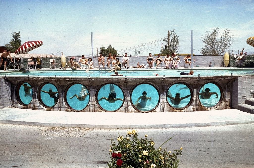 Swimmers look through underwater portholes in a pool at an unidentified hotel, Las Vegas, 1955