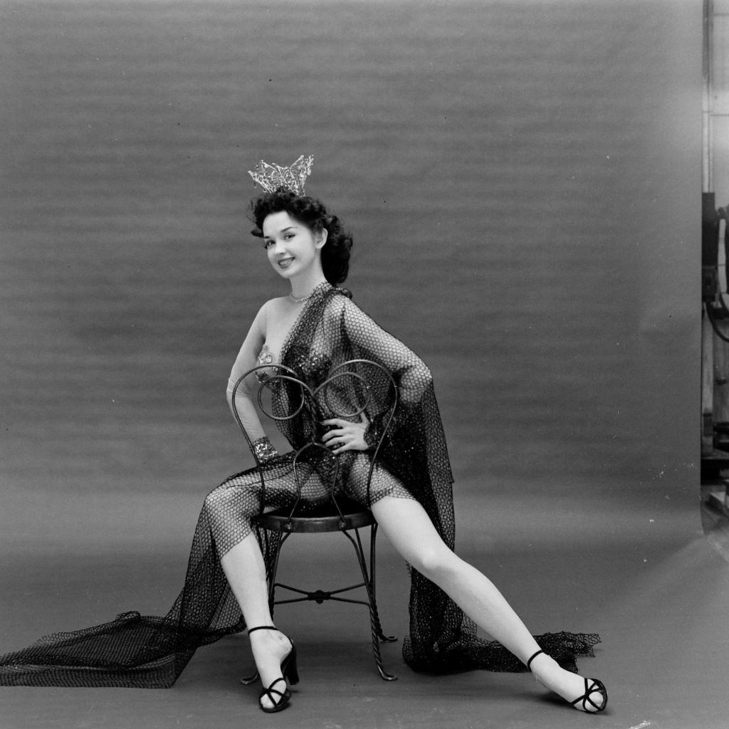 Showgirl and burlesque dancer sitting on a chair, Las Vegas, 1952