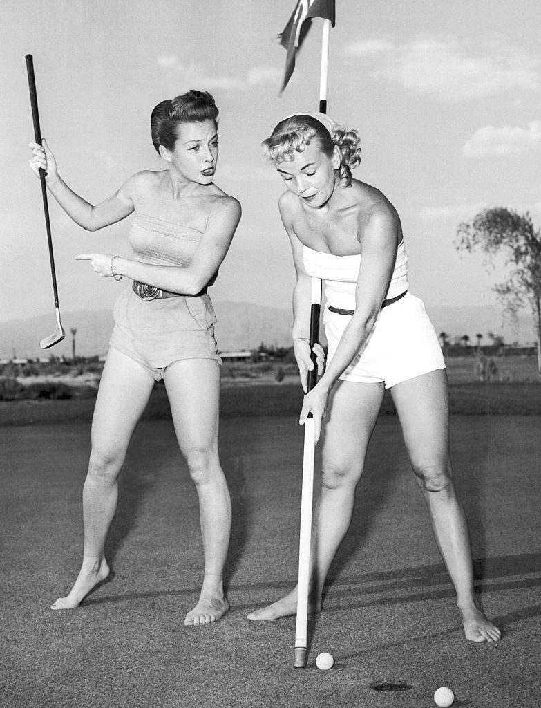 Showgirls Joy Skylar and Florence Walters practicing for the special showgirl golf tournament to be held at the Desert Inn Country Club, Las Vegas, 1953
