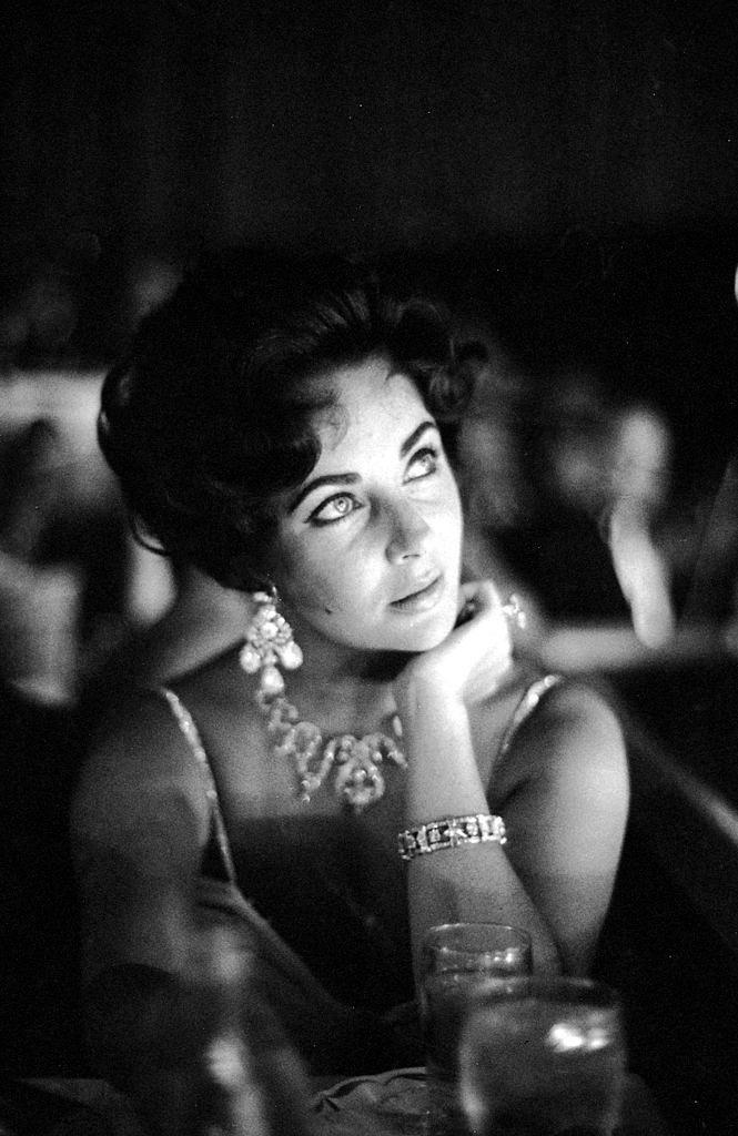 Actoress Elizabeth Taylor watches her fiance Eddie Fisher as he performs on stage at the Tropicana in Las Vegas, 1959.