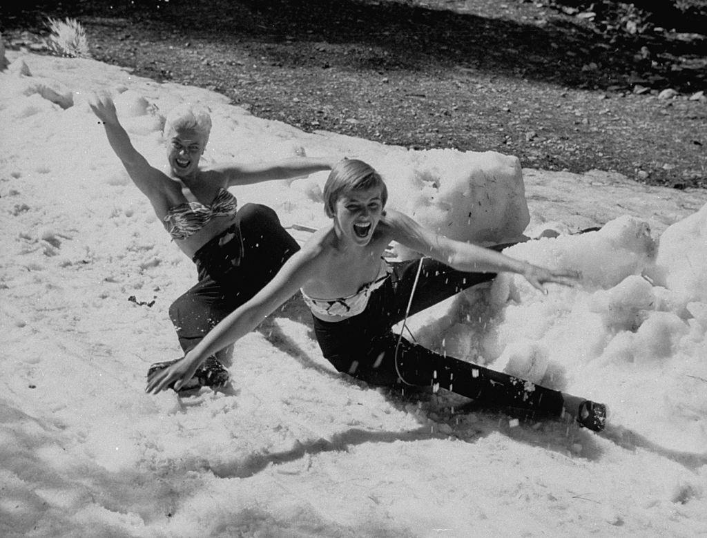 Las Vegas Chorus Girl, Kim Smith playing in the snow with her friend, 1954.