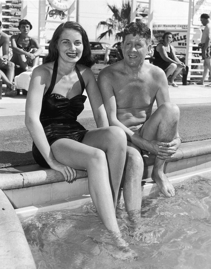 American actor and singer Rudy Vallee and his wife, Eleanor Norris, relaxing poolside at the El Rancho Vegas resort, 1950.