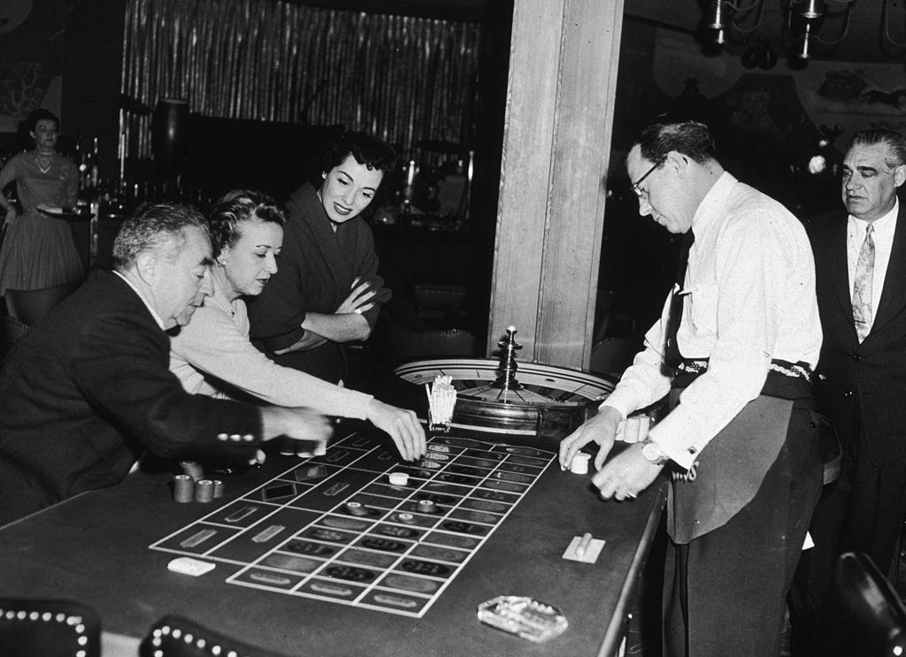 American opera singer, Marguerite Piazza, watching guests play roulette at the Sands Hotel in Las Vegas, 1955.