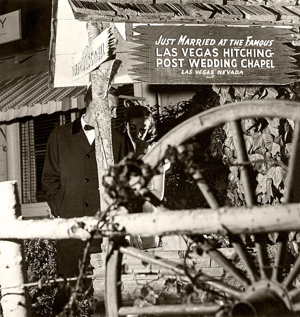 Couple stand outside the famous Las Vegas Hitching Post Wedding Chapel, 1959.