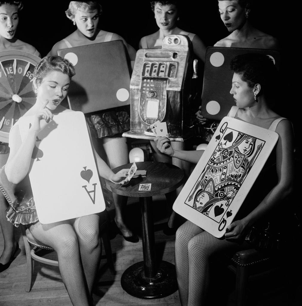 Two young women give away a little too much in a game of cards at the Silver Slipper casino in Las Vegas, 1953