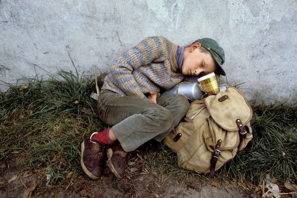 Tired young boy during pilgrimage on foot Warsaw-Czestochowa, 1982.