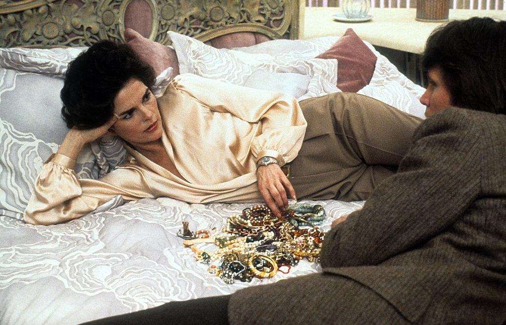 Ali MacGraw lies in a scene from the film 'Just Tell Me What You Want', 1980.