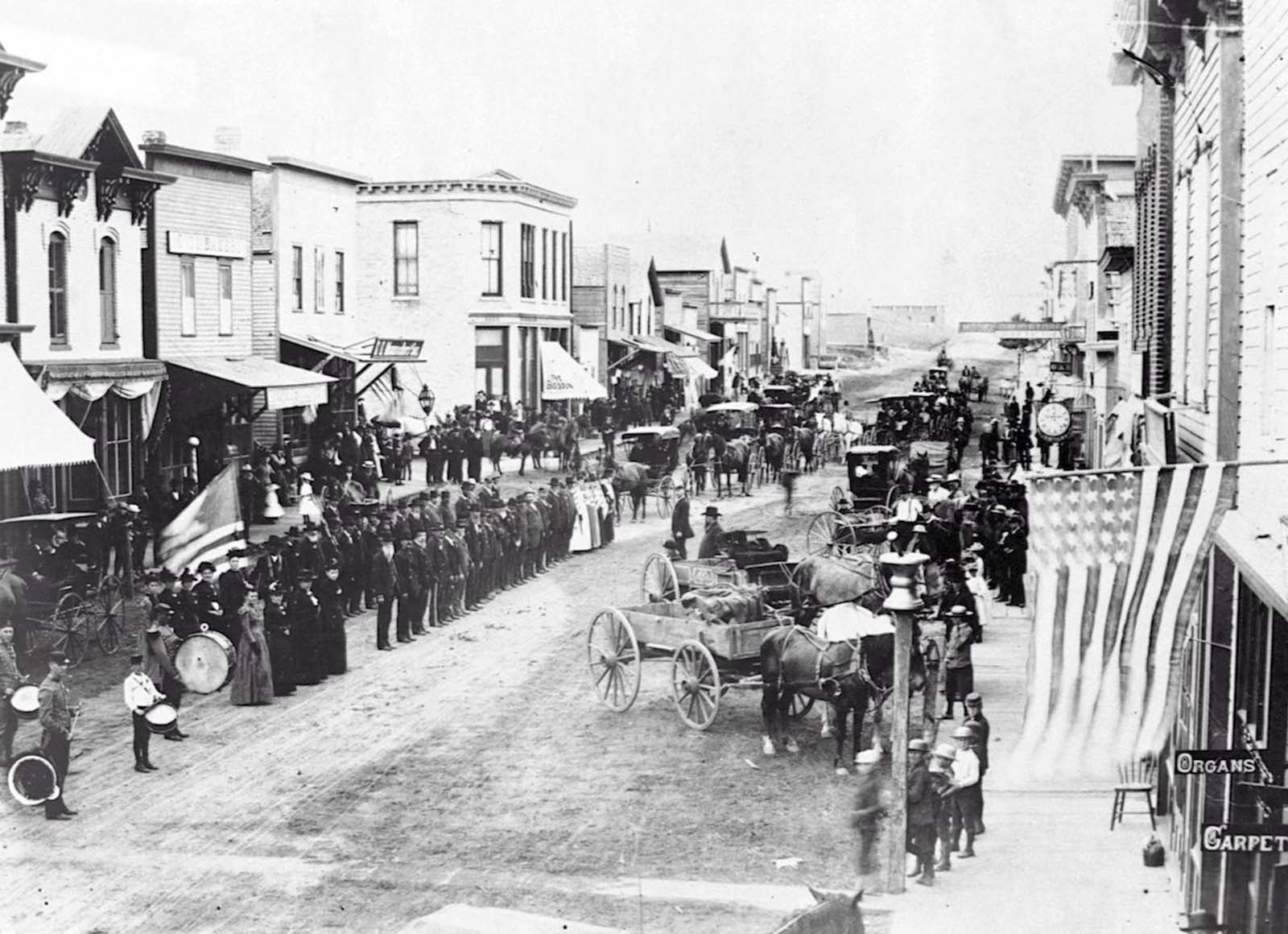 Civil War veterans on Fourth of July, or Decoration Day, on review on the main street of Ortonville, Minnesota. 1880.