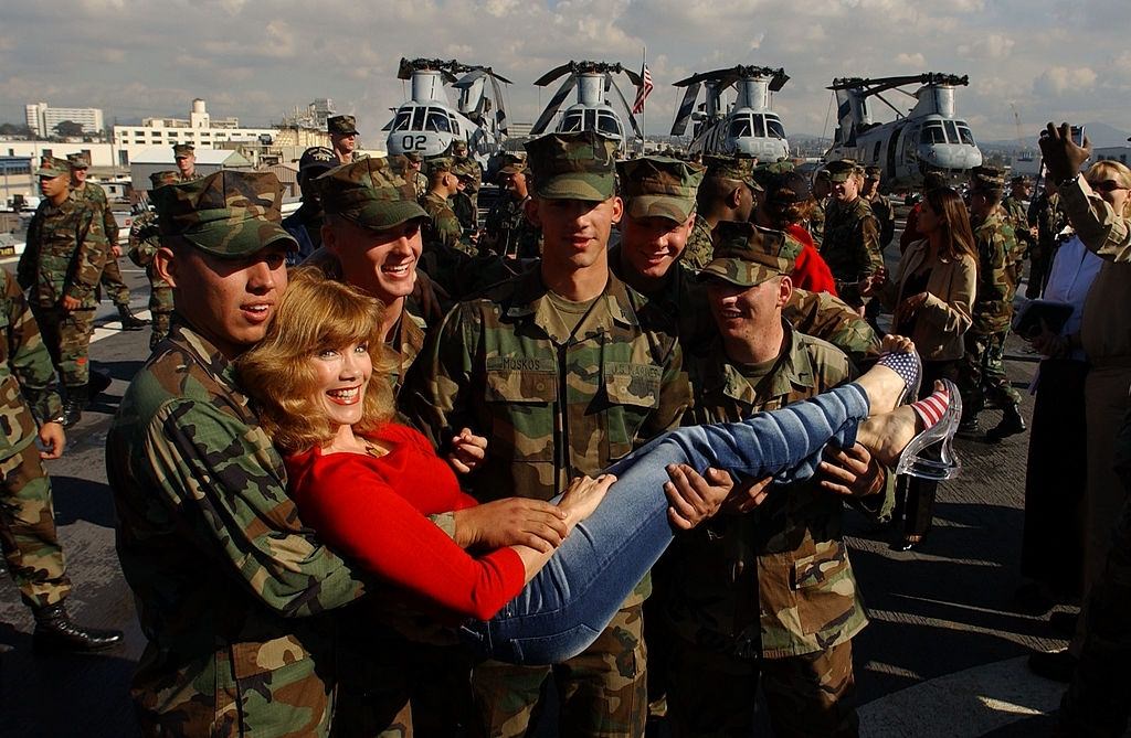 Barbie Benton poses with Marines and Sailors aboard the USS Ogden November 30, 2001