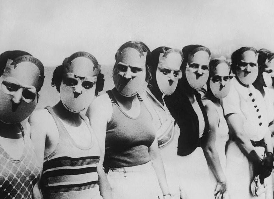 Contestants in the Miss Lovely Eyes beauty pageant in Florida wear masks to obscure the rest of their faces, Circa 1930.