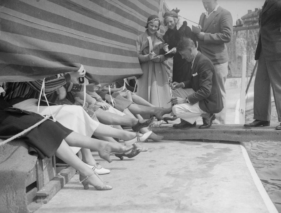 Judges and competitors at a prettiest ankle contest. Cliftonville, Kent, England, 1933.