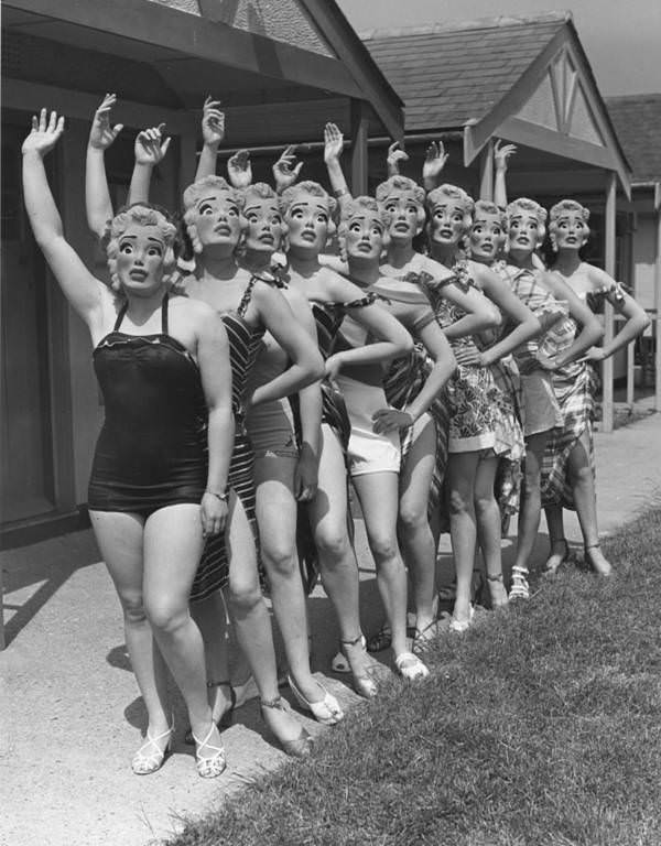 Women at Butlin's holiday camp wear Marilyn Monroe face masks. Clacton-on-Sea, England, 1952.