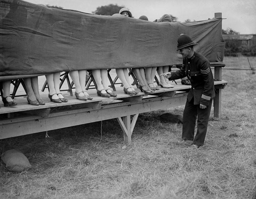 A policeman judges an ankle competition in Hounslow, London, 1930