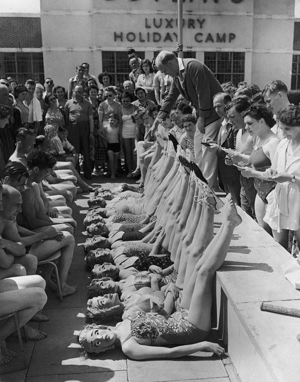 Beauty contestants are judged solely on their figures, thanks to the introduction of papier mache masks, at Butlin's holiday camp in Clacton-on-Sea, England, 1952