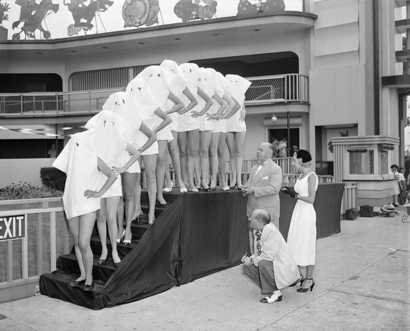 Participants in the Beautiful Leg Contest wear pillow cases over their heads so that the judges can see only their legs. Palisades Amusement Park, New Jersey, 1951.