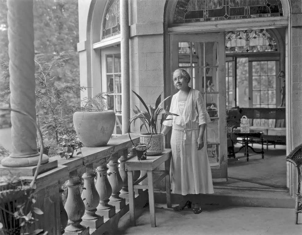 Dr. Anna J. Cooper, in her garden, home and patio, 1930.