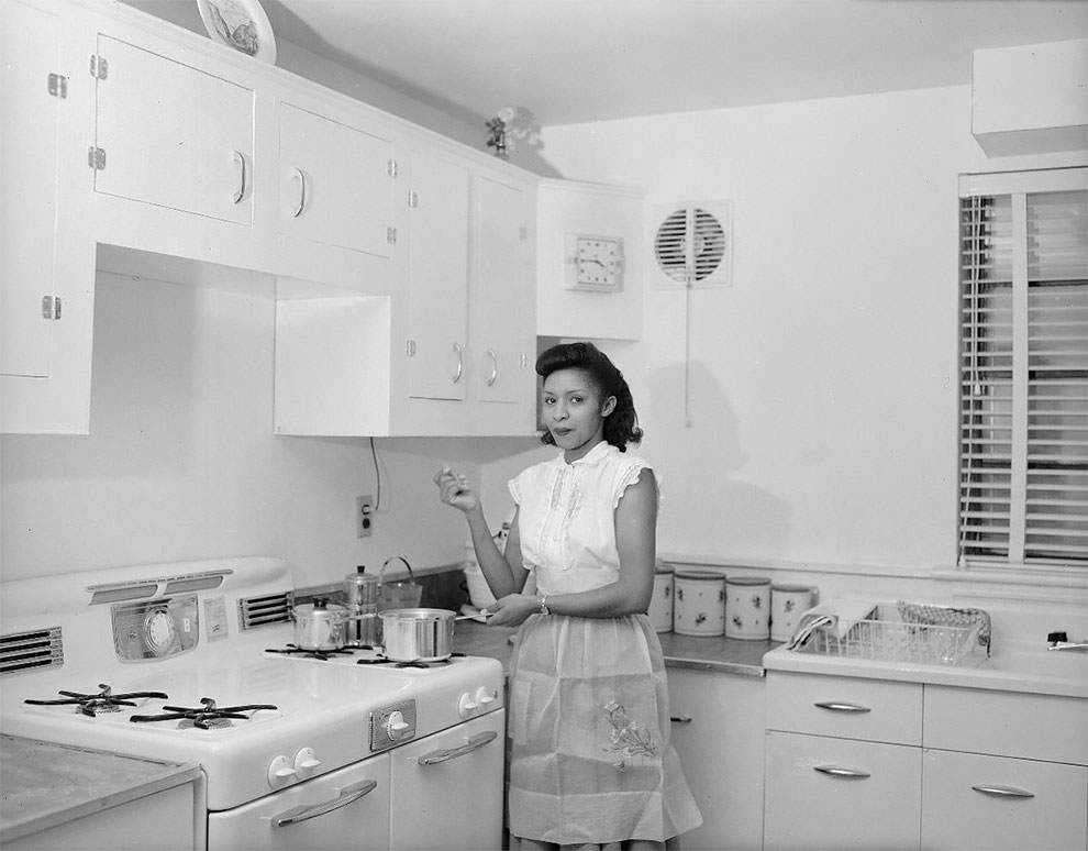 Woman standing in a kitchen in Eastland Gardens.