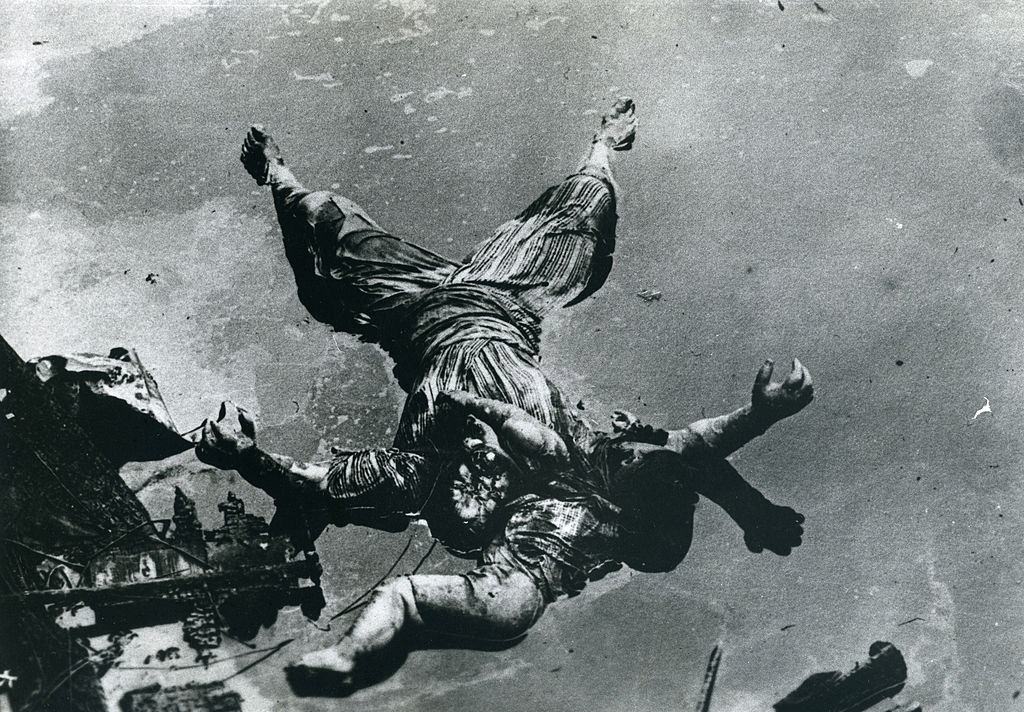 Bodies of a mother and her baby of the Great Kanto Earthquake victims float in a river in September 1923 in Tokyo.