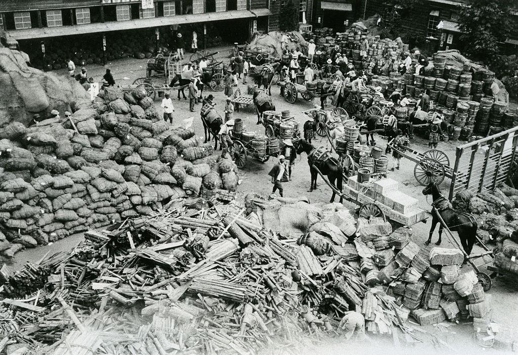 Aid supply are collected at Ichigaya Elementary School after the Great Kanto Earthquake victims and debris float in Sumida River in September 1923.