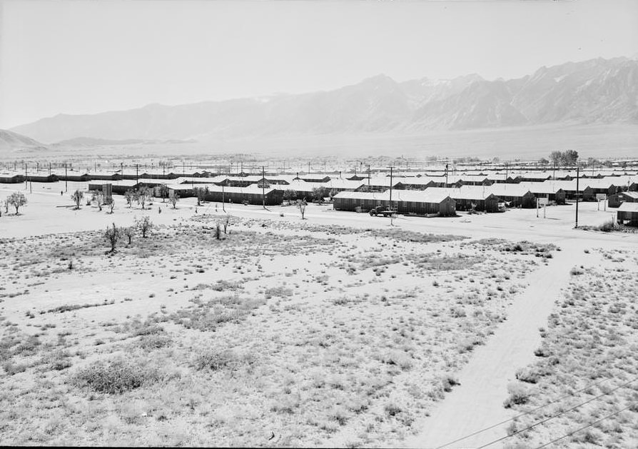 Buildings and connecting roadways, mountain range in background.