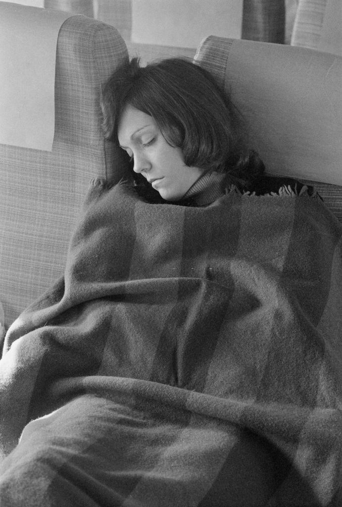 Karen Carpenter sleeping on an aircraft during a European tour, 1974.