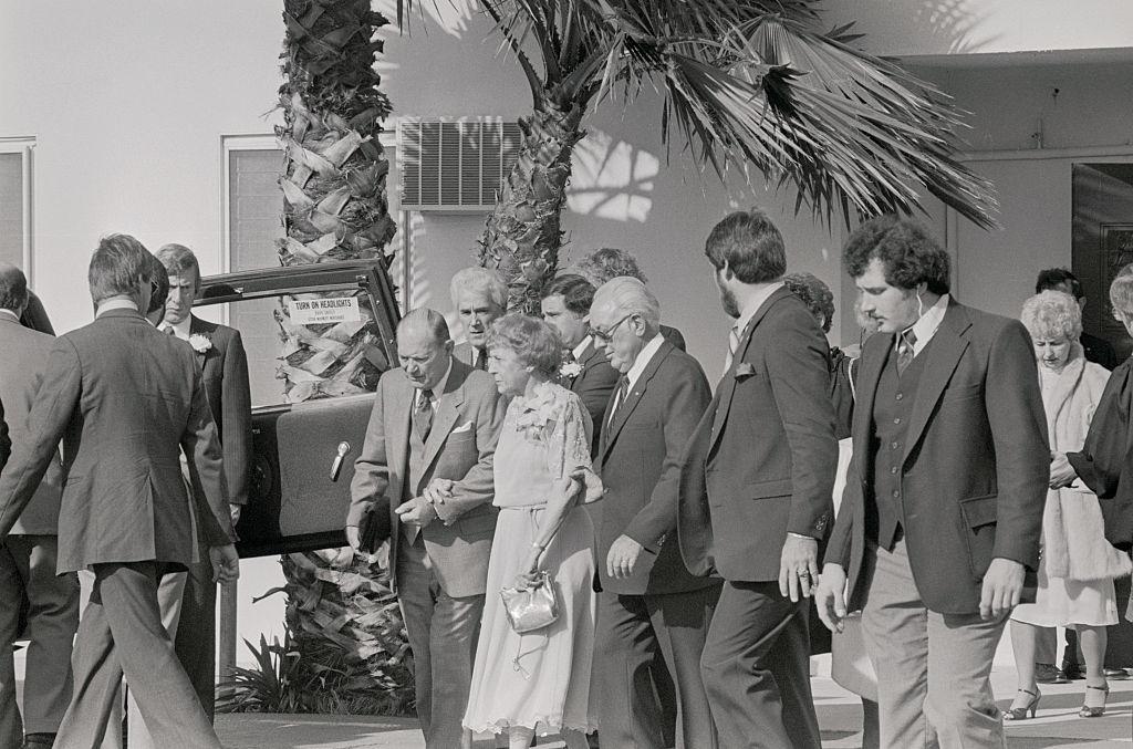 The parents of Karen Carpenter leave Downey United Methodist Church here, after attending the funeral of Karen, 1983.