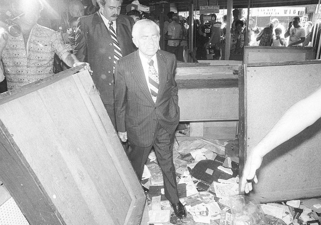 Mayor Abe Beame visits merchants on looting after the 1977 blackout power failure at Broadway, near Greene Avenue in Brooklyn, New York City, 1977.