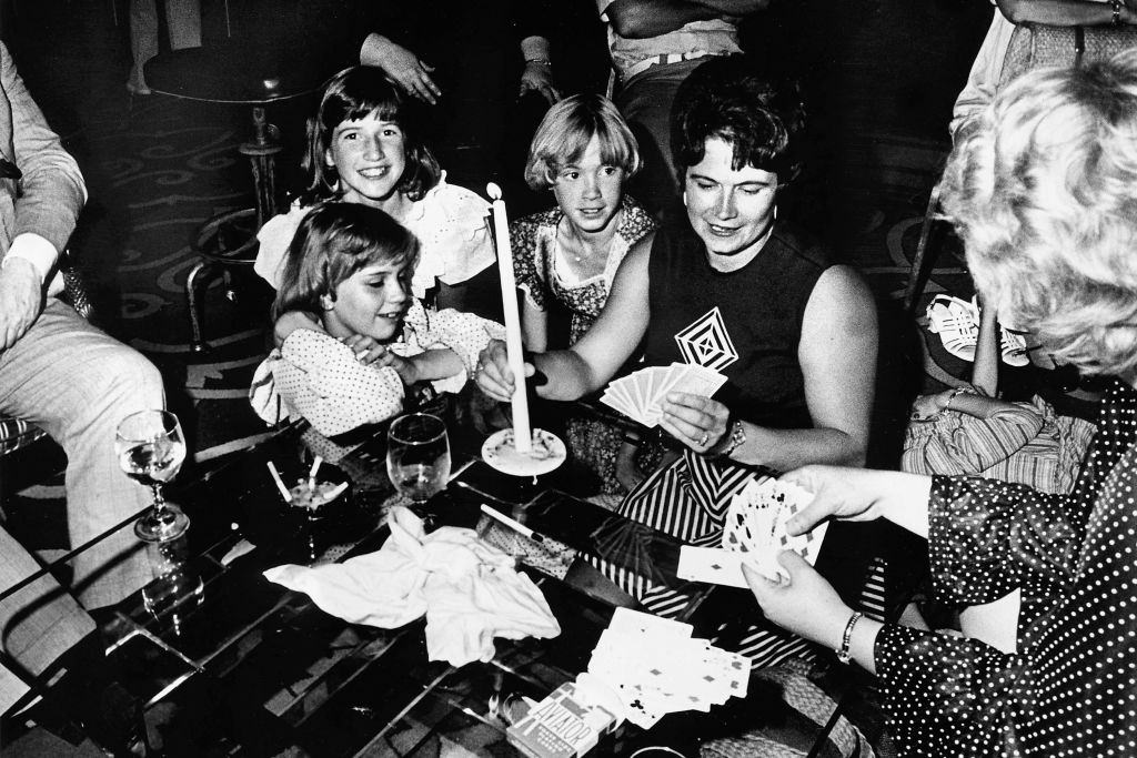 People playing poker game by candlelight during a power cut, New York, July 13, 1977