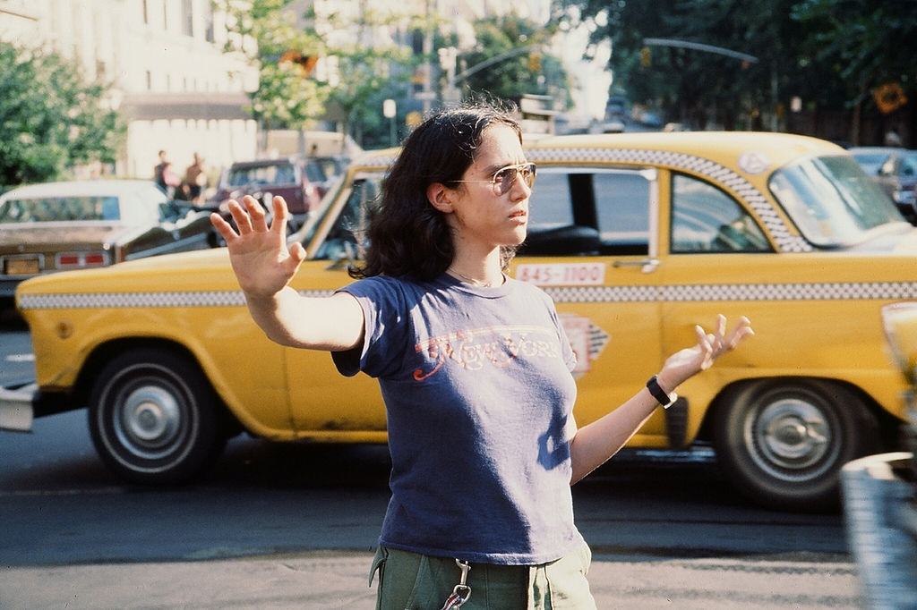 A young woman directing traffic in the wake of the New York City blackout, 1977.