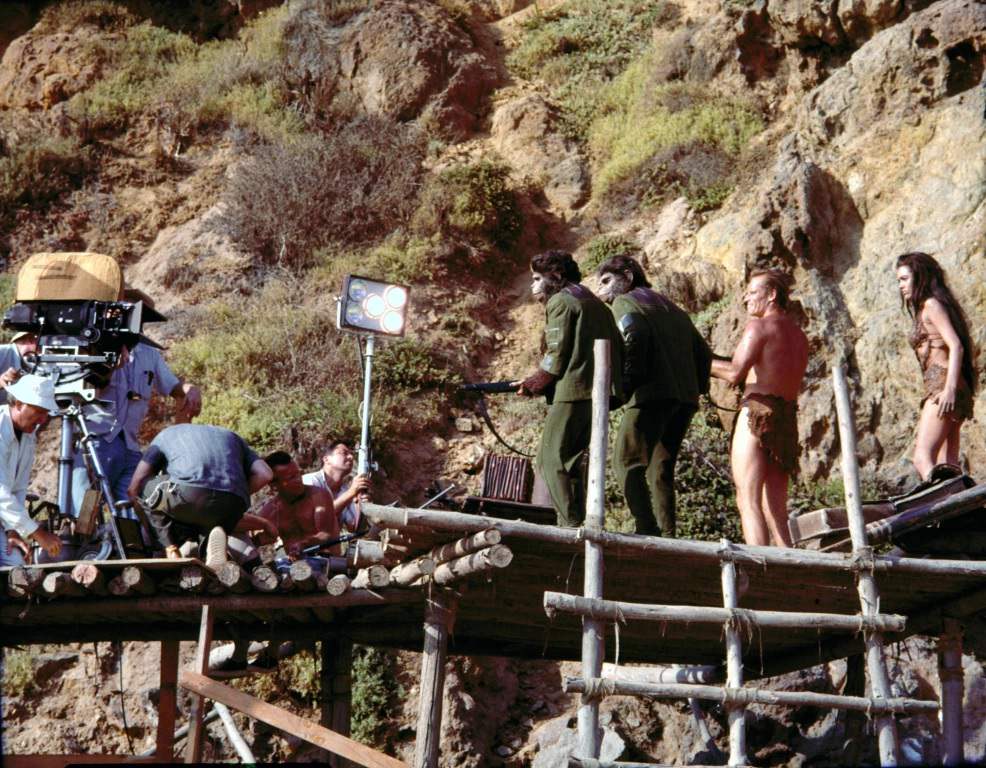 Actors Lou Wagner, Roddy McDowall, Charlton Heston, and Linda Harrison on set of the Planet of the Apes, 1968.