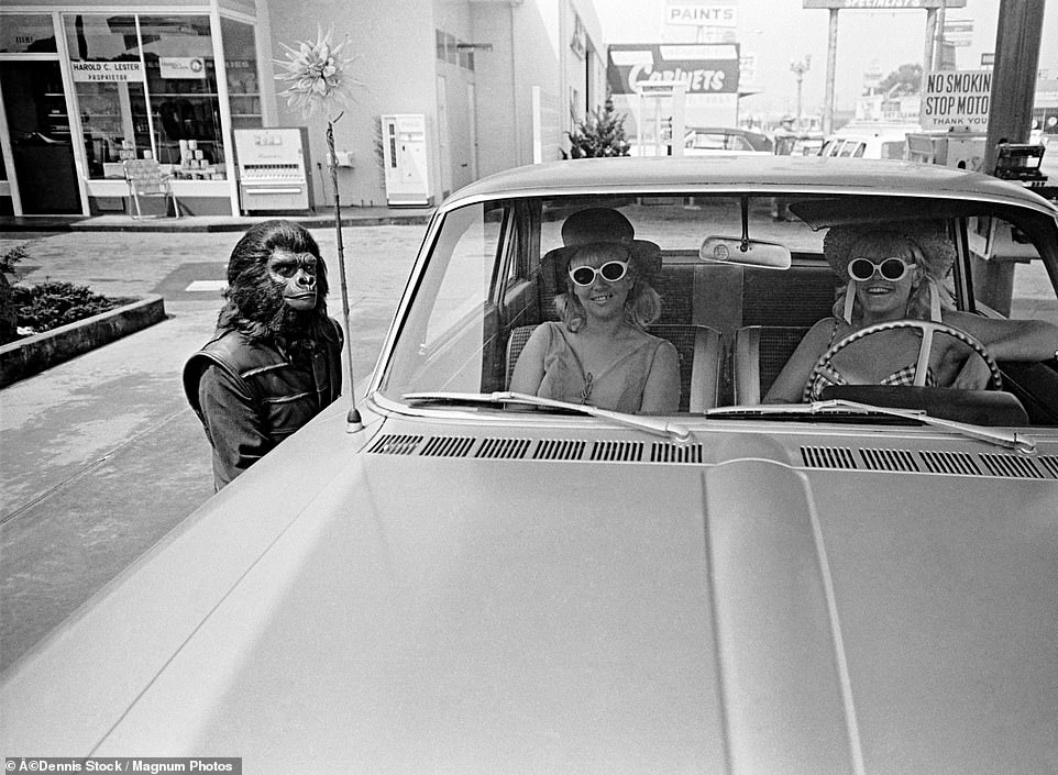 The actors enjoying downtime while in-between takes including this goofy character posing next to two women in a car