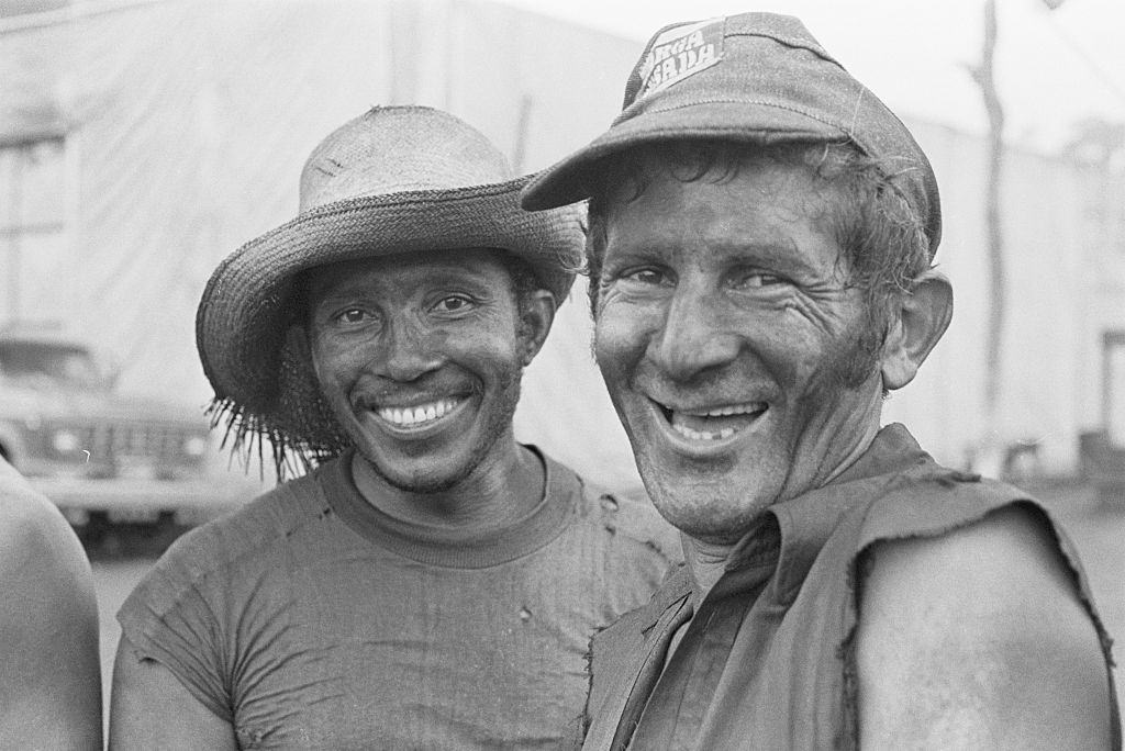 The mud on their faces can't hide the smiles of two gold miners seeking pay dirt in the Amazon.