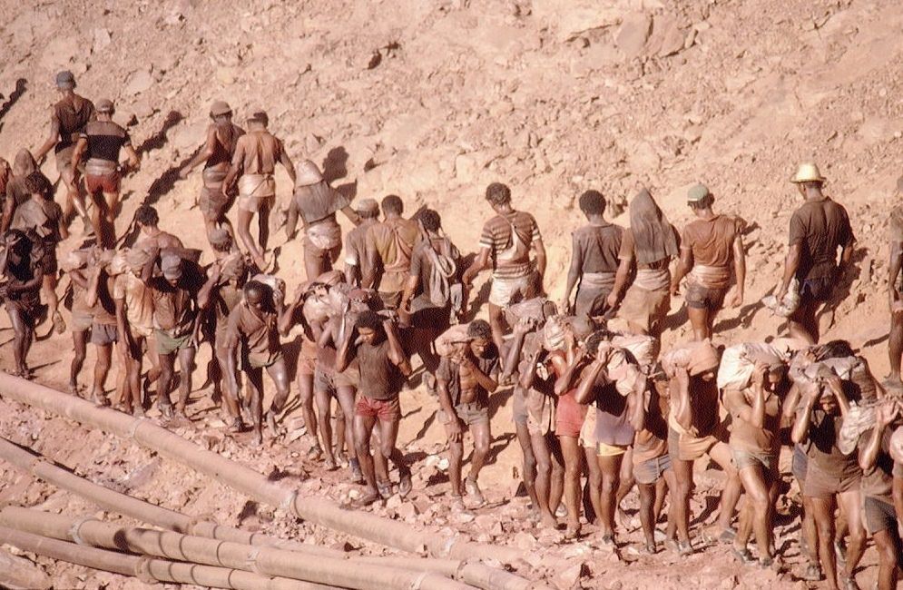 Workers taking the raw material from gold mine.