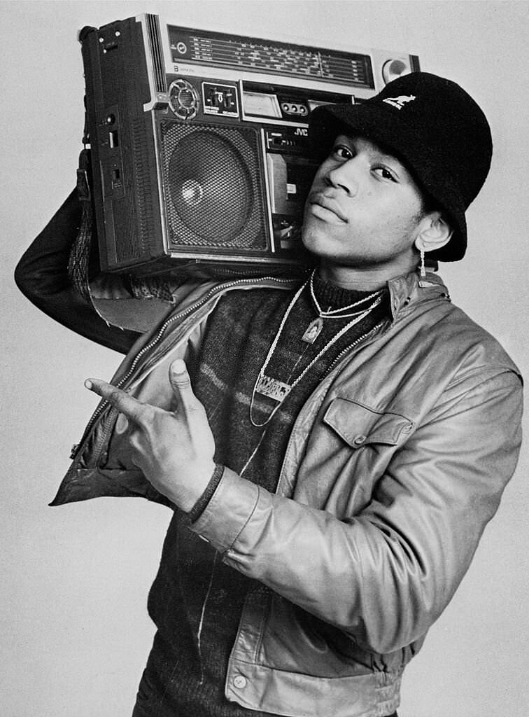 Rapper LL Cool J, carries a boombox upon his right shoulder while posing for a studio portrait, 1985
