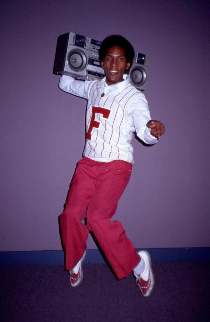 Musician Jessie Daniels of the R and B vocal group dancing with a boombox, 1985